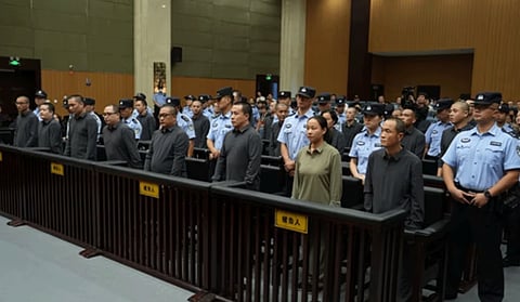 Defendants stand to hear their sentencing at the Wenzhou Intermediate People's Court in Zhejiang Province, China on September 29, 2025.