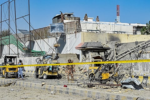 Security personnel inspect an explosion site outside the Frontier Corps (FC) headquarters in Quetta on September 30, 2025.