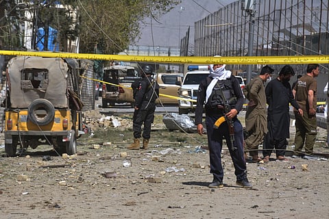 Security officials examine damaged vehicles at the site of a powerful car bombing, in Quetta, Pakistan, on Sept. 30, 2025.