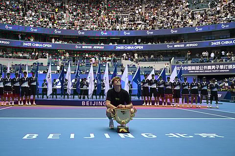 Italy’s Jannik Sinner poses with the trophy after winning the men’s singles final against USA’s Learner Tien at the China Open tennis tournament in Beijing on October 1, 2025.