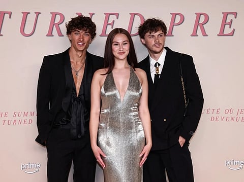 US actor Gavin Casalegno, US actress Lola Tung and US actor Christopher Briney pose on the red carpet upon arrival for the Special screening of the final episode of the serie "The Summer I turned pretty", in Paris, on September 17, 2025.