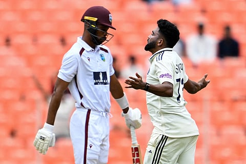 India's Mohammed Siraj (R) celebrates after taking the wicket of West Indies' captain Roston Chase (L) during the first day of the first Test cricket match between India and West Indies at the Narendra Modi Stadium in Ahmedabad on October 2, 2025.