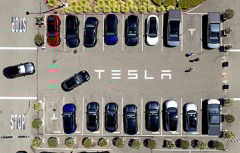 FILE - Tesla vehicles line a parking area at the company's Fremont, Calif., factory, Aug. 5, 2025. (AP Photo/Noah Berger)