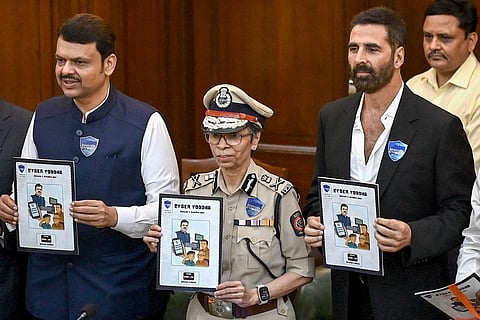 Devendra Fadnavis (L), Chief Minister of Maharashtra state, Rashmi Shukla (C), Director General of Police (DGP) of Maharashtra and Bollywood actor Akshay Kumar attend the inauguration event of Cyber Awareness Month 2025 at State Police Headquarters in Mumbai on October 3, 2025.