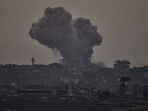 Smoke rises amid buildings, that were destroyed during the Israeli ground and air operations, following an Israeli military strike in the northern Gaza Strip, as seen from southern Israel, Friday, October 3, 2025.