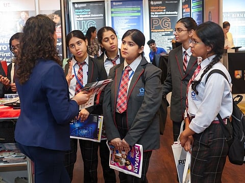 Students attentively listening to a representative at the Gulf News Edufair Dubai 2025.