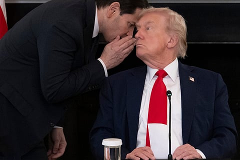 US Secretary of State Marco Rubio (L) whispers to US President Donald Trump after handing him a note saying the Middle East peace deal is “very close” during an event at the White House in Washington, DC. Photo taken on October 8, 2025.