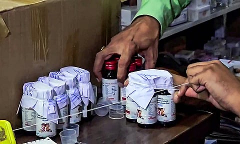 The Drugs Department sealing the Coldrif cough syrup containers during a raid on an Ayush firm, in Chhindwara.