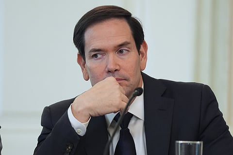 Secretary of State Marco Rubio listens before interrupting President Donald Trump during a roundtable meeting on antifa in the State Dining Room at the White House, Wednesday, Oct. 8, 2025, in Washington.