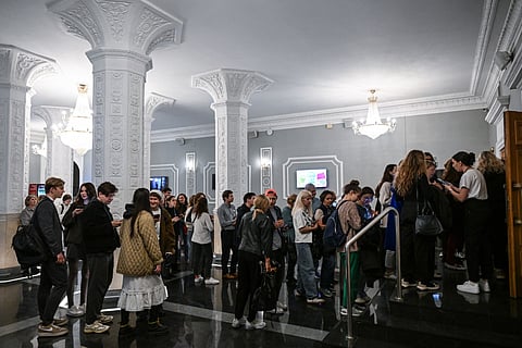 People queue to enter a cinema hall for a screening of French director Cedric Klapisch's dramatic comedy "Colours of Time" ("La venue de l'avenir") - recently premiered at the 78th edition of the Cannes Film Festival, in Moscow on September 23, 2025.