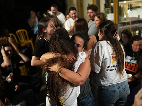 Relatives and supporters of Israeli hostages held by Hamas in the Gaza Strip celebrate after the announcement that Israel and Hamas have agreed to the first phase of a peace plan, as they gather at a plaza known as the hostages square in Tel Aviv, Israel.