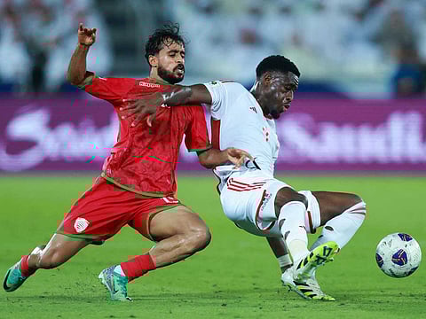 Oman's midfielder #15 Nasser Al-Rawahi and UAE's defender #4 Kouame Kouadio fight for the ball during the FIFA World Cup 2026 Asian qualifier football match between United Arab Emirates and Oman at Jassim Bin Hamad Stadium in Doha on October 11, 2025.