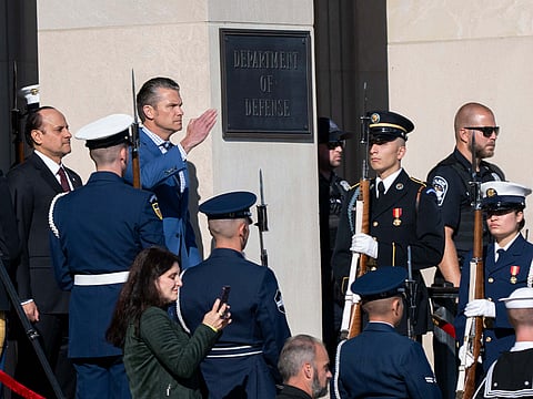 Defence Secretary Pete Hegseth salutes during a welcome ceremony for Qatar Minister of Defence Sheikh Saoud Al Thani, left, at the Pentagon, on Friday, October 10, 2025 in Washington.
