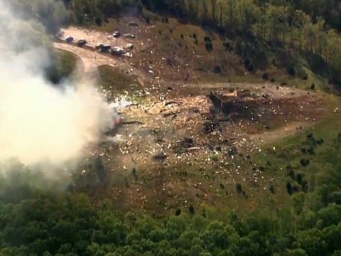 Smoke fills the air as debris covers the ground and vehicles after a powerful blast ripped through a military explosives manufacturing plant in Hickman County, Tenn., on Friday, Oct. 10, 2025.