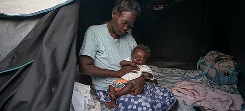 Many people in Haiti displaced by violence, like this mother and baby, struggle to find enough to eat.