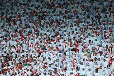 UAE fans cheer during the FIFA World Cup 2026 Asian qualifier football match between United Arab Emirates and Oman at Jassim Bin Hamad Stadium in Doha on October 11, 2025.