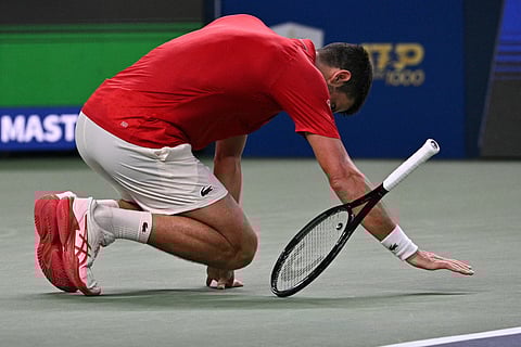 Djokovic falls to the court during his men's singles semi-final match against Vacherot.