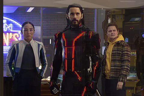 This image released by Disney shows Greta Lee, from left, Jared Leto and Arturo Castro in a scene from "Tron: Ares."