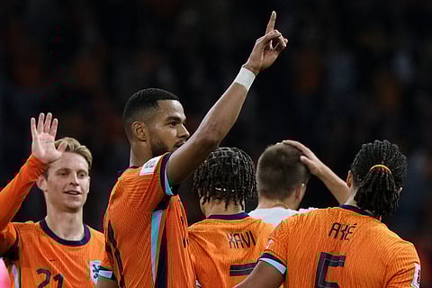 Netherlands' Cody Gakpo, center, celebrates after scoring his side's fourth goal during a World Cup 2026 group G qualifying soccer match between the Netherlands and Finland in Amsterdam, Sunday, Oct. 12, 2025.