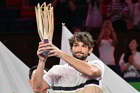 Monaco's Valentin Vacherot holds up the trophy after his victory against France’s Arthur Rinderknech during the men’s singles final at the Shanghai Masters tennis tournament in Shanghai on October 12, 2025.