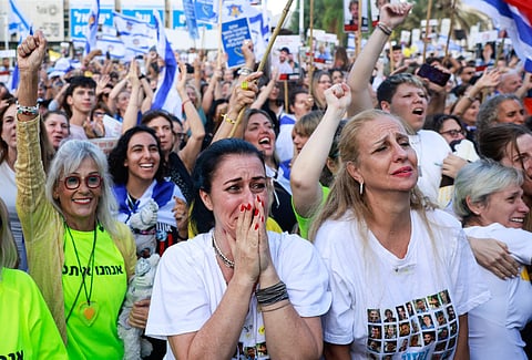 A woman reacts as people celebrate at Hostage Square in Tel Aviv as news came out that a Red Cross convoy is on its way to pick up a second group of Israeli hostages to be freed by Hamas on October 13, 2025.