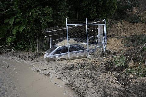 A vehicle is partially covered in mud after floods triggered by heavy rains in Tenango de Doria, Hidalgo state, Mexico, on October 13, 2025.