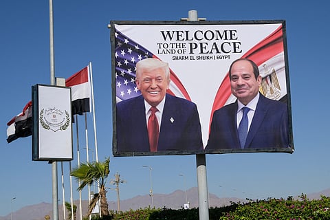 This photograph shows a billboard bearing the portraits of US President Donald Trump and Egyptian President Abdel Fattah Al Sisi outside the convention centre ahead of the Sharm Al Sheikh Peace Summit in the Egyptian Red Sea resort town of Sharm Al Sheikh on October 13, 2025.