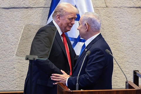 US President Donald Trump and Israel's Prime Minister Benjamin Netanyahu talk at the Israeli parliament, the Knesset, in Jerusalem on October 13, 2025.