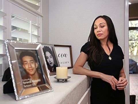 Megan Garcia stands next to a picture of her son Sewell Setzer III at her home in Orlando, Florida.