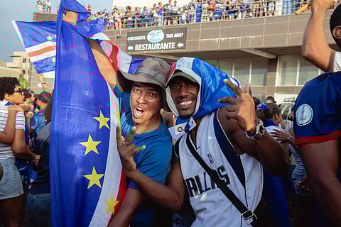 Supporters celebrate Cape Verde’s victory against Eswatini during the FIFA World Cup 2026 Africa qualifiers group D match at a fan zone in Sao Vicente, Cape Verde, on October 13, 2025.