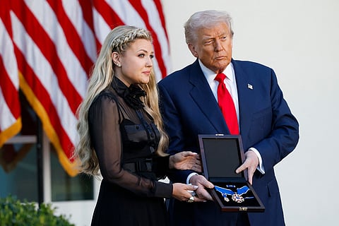Trump presents the Medal to his wife Erika Kirk (L) during a ceremony in the Rose Garden of the White House.