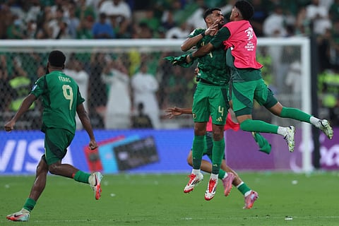 Saudi Arabia players celebrate after the Fifa World Cup 2026 Asian qualifier football match against Iraq at King Abdullah Sports City in Jeddah on October 14, 2025.