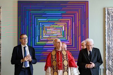 This photo taken and handout on October 14 2025, by The Vatican Media shows Pope Leo XIV (C) and Italy's President Sergio Mattarella (R) during an official visit at the Quirinale Presidential Palace, in Rome.