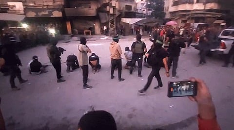Graphic videos circulating on social media show masked Hamas gunmen executing eight blindfolded men in Gaza City’s Al Sabra neighbourhood before a crowd of onlookers.