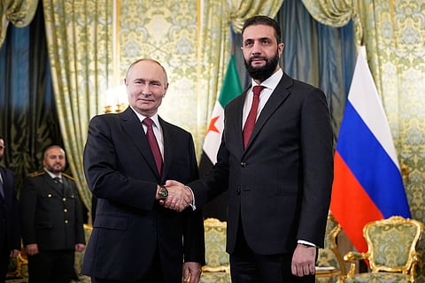 Russian President Vladimir Putin, left, and Syrian interim President Ahmad Al Sharaa during their meeting at the Grand Kremlin Palace in Moscow on October 15, 2025.
