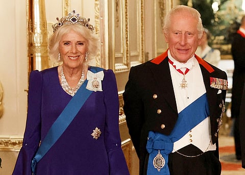 Britain's Queen Camilla, left, and King Charles III, right, pose for a photo before a State Banquet at Windsor Castle, in Windsor, England, Sept. 17, 2025.