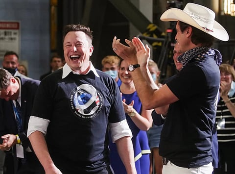 SpaceX CEO Elon Musk celebrates with his brother Kimbal Musk (in hat) after the launch of a SpaceX Falcon 9 rocket and Crew Dragon spacecraft on NASA's SpaceX Demo-2 mission to the International Space Station from NASA's Kennedy Space Center in Cape Canaveral, Florida, US.