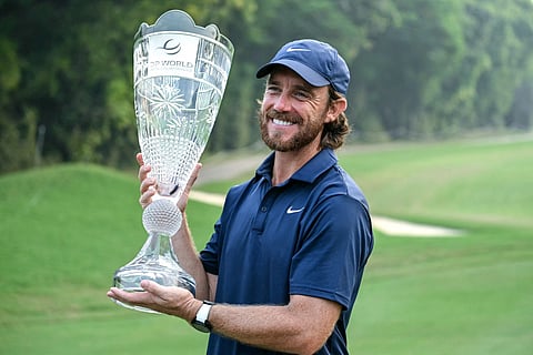 England's Tommy Fleetwood poses with the trophy after winning the DP World India Championship 2025 golf tournament at the Delhi Golf Club in New Delhi on October 19, 2025.