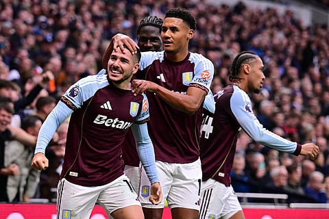 Aston Villa's Argentinian midfielder Emiliano Buendia (L) celebrates with teammates after scoring their second goal during the English Premier League football match against Tottenham Hotspur at the Tottenham Hotspur Stadium in London, on October 19, 2025.
