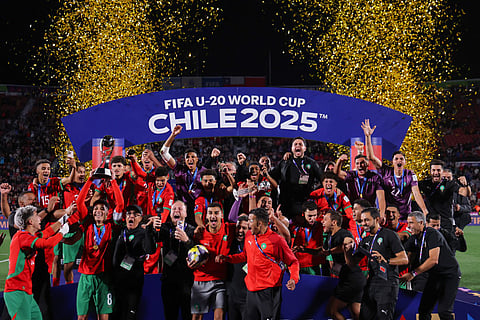 Morroco's team members celebrate with the trophy after winning the 2025 FIFA U-20 World Cup final football match between Argentina and Morocco at the National Stadium in Santiago on October 19, 2025.