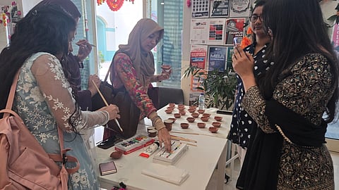 Student painting diyas for a Diwali celebration in Dubai