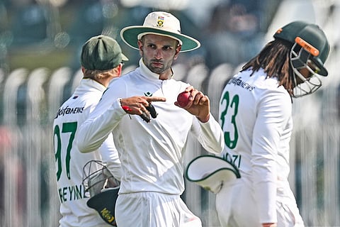 South Africa's Keshav Maharaj (C) gestures as he celebrates after taking his seventh wicket of Pakistan's Asif Afridi, at the end of the first innings during the second day of the second Test cricket match at the Rawalpindi Cricket Stadium in Rawalpindi on October 21, 2025.
