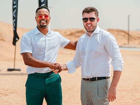Patrice Evra (left) shakes hands with Andrei Charapenak, CEO, Major Developments