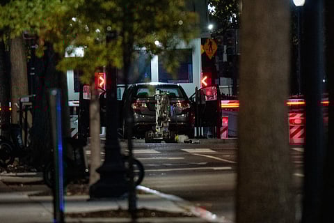 A bomb detection robot inspects a vehicle that rammed a security barricade at the White House complex on October 21, 2025 in Washington, DC. The Secret Service reported that one individual was arrested and that the vehicle is now deemed safe.