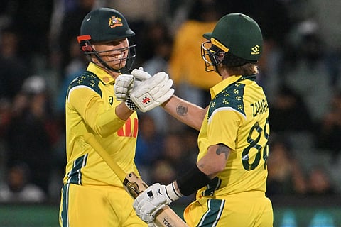 Australis’s Cooper Connolly (L) and Adam Zampa celebrate their win during the second one-day international (ODI) men's cricket match against India at the Adelaide Oval in Adelaide on October 23, 2025.