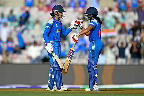 India's Smriti Mandhana (L) celebrates after scoring a half-century with Pratika Rawal during the ICC Women's Cricket World Cup 2025 one-day international (ODI) match against New Zealand at the DY Patil Stadium in Navi Mumbai on October 23, 2025.