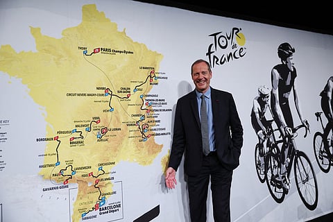 Tour de France General Director Christian Prudhomme poses for a picture in front of the map showing the women's route during the presentation of the official routes of the 2026 edition of the men's and women's Tour de France cycling race in Paris on October 23, 2025.