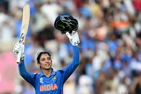 India's Smriti Mandhana celebrates after scoring a century (100 runs) during the ICC Women's Cricket World Cup 2025 one-day international (ODI) match against New Zealand at the DY Patil Stadium in Navi Mumbai on October 23, 2025.