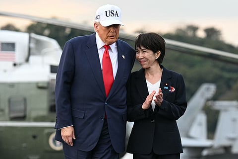 US President Donald Trump (L) and Japan's Prime Minister Sanae Takaichi arrive on board the US Navy's USS George Washington aircraft carrier at the US naval base in Yokosuka on October 28, 2025.