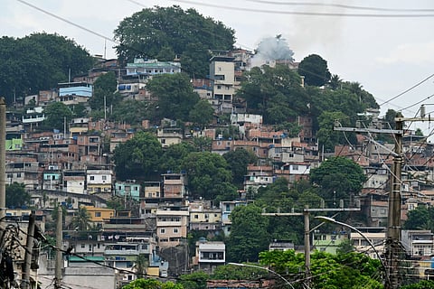 Smoke rises from a house in the Vila Cruzeiro favela at the Penha complex in Rio de Janeiro, Brazil, on October 29, 2025, in the aftermath of Operacao Contencao (Operation Containment).